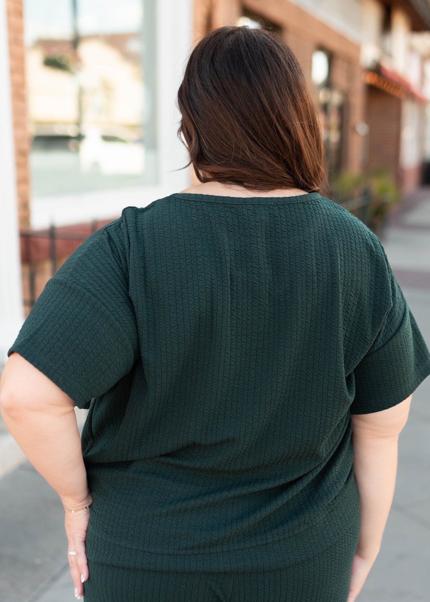Back view of the plus size forest green top