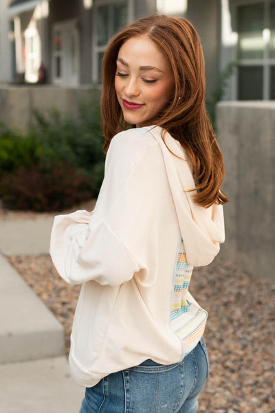 Side view of a oatmeal top with long sleeves and a hood