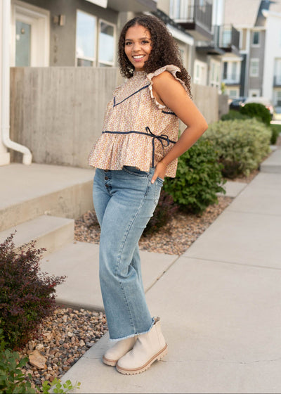 Modest babydoll style taupe floral top with navy trim and bow on the side