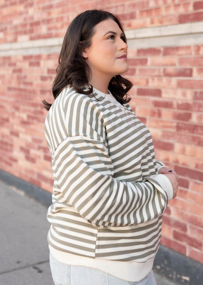 Side view of the plus size olive striped sweatshirt