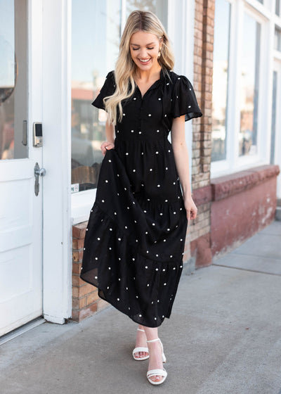 Tie at the neck on the modest black polka dot dress with buttons on the bodice
