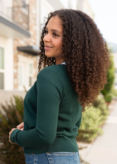 Modest side view of the pine green cardigan