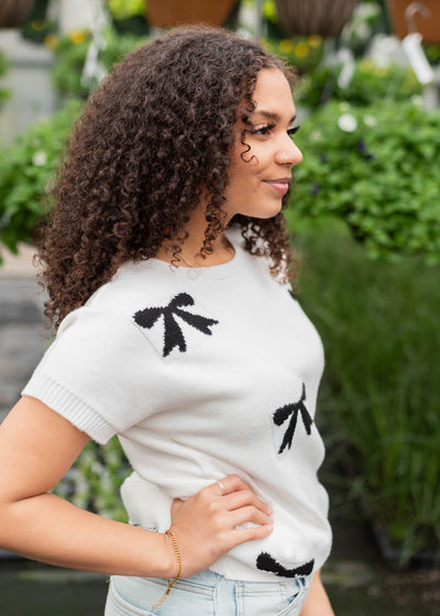 Side view of the black bow sweater