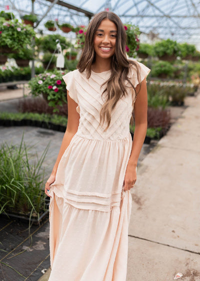 Beige swiss dot dress with pleats on the skirt