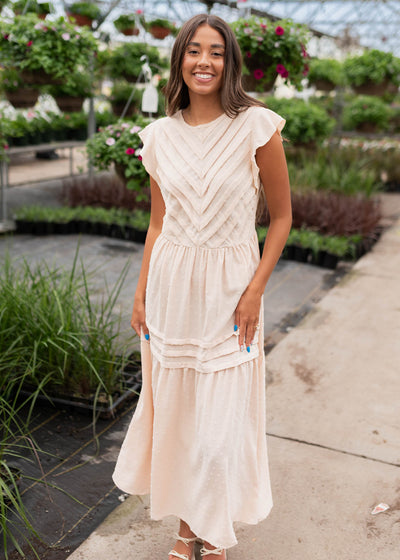 Ruffle cap sleeve on the beige swiss dot dress