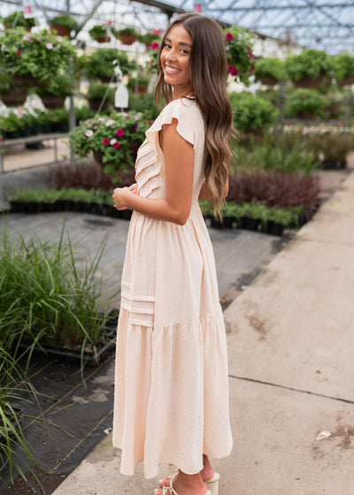 Side view of the beige swiss dot dress