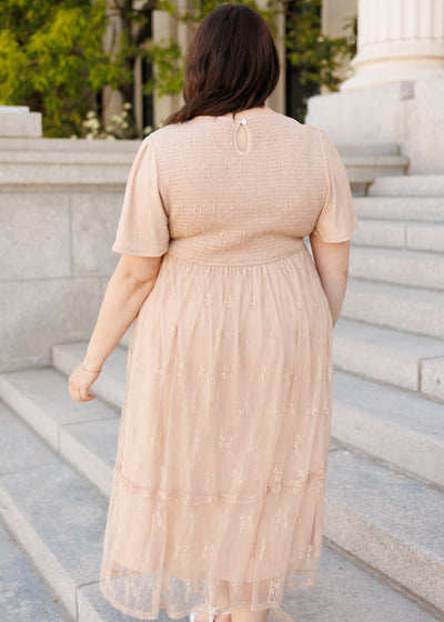 Back view of the beige smocked lace dress
