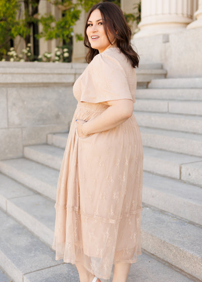 Side view of the beige smocked lace dress in plus size