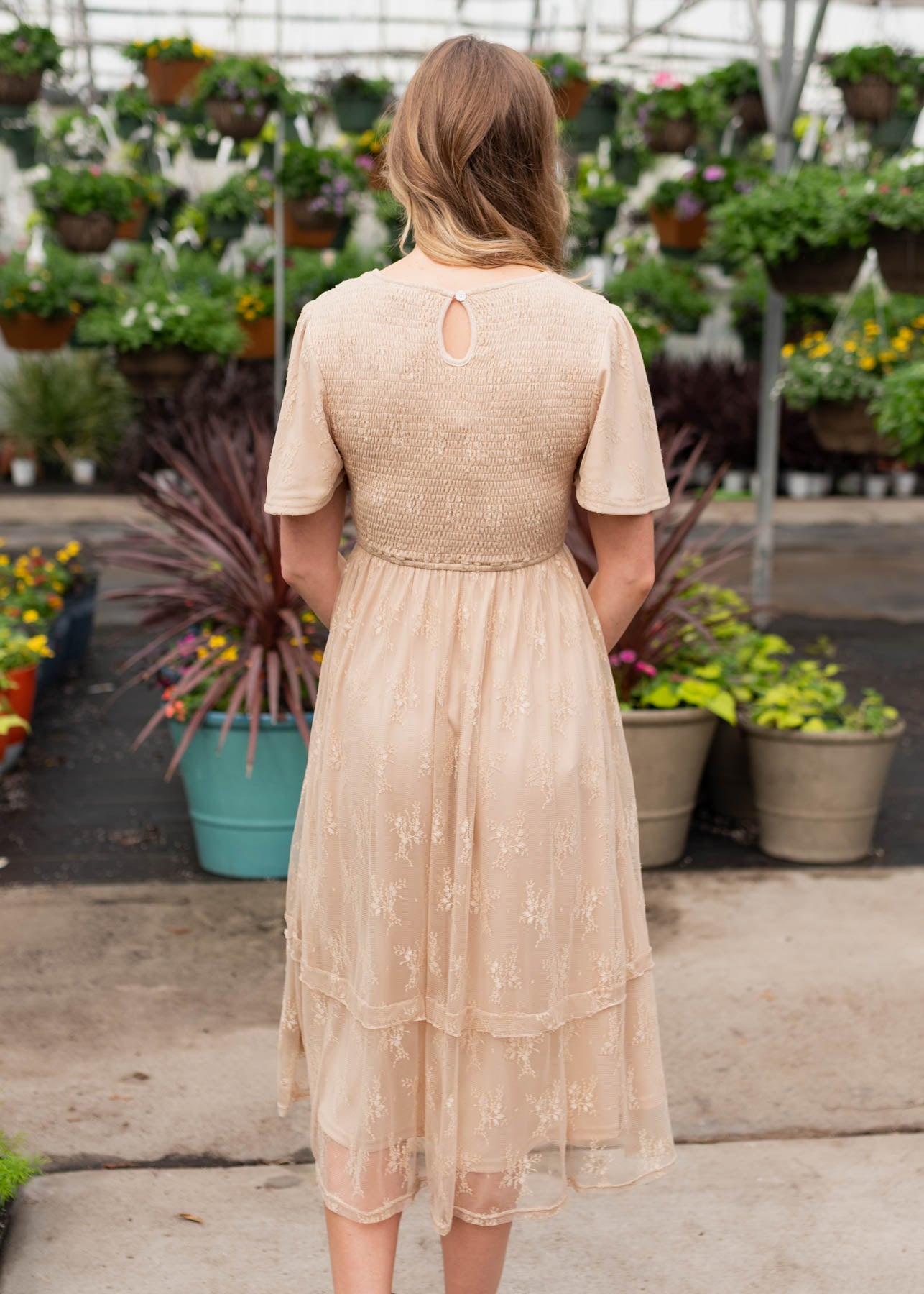 Back view of the beige smocked lace dress