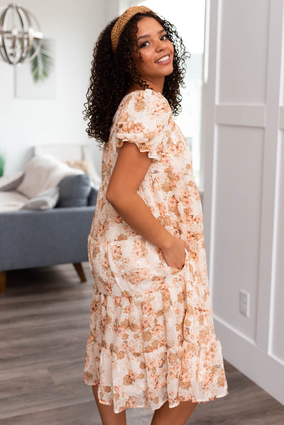 Side view of a peach floral tiered dress
