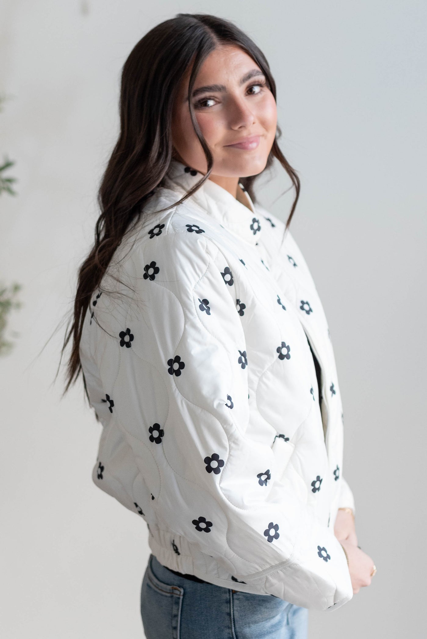 Side view of the ivory flower puffer jacket