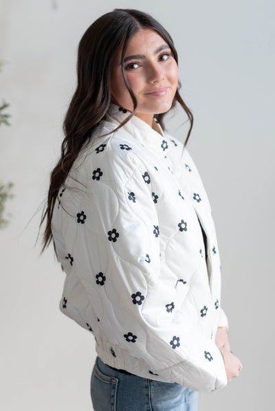 Side view of the ivory flower puffer jacket