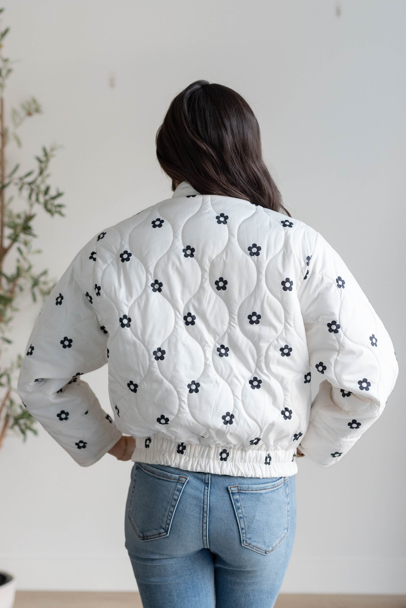 Back view of the ivory flower puffer jacket