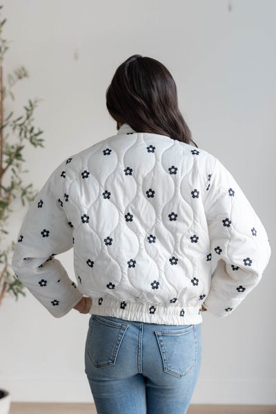 Back view of the ivory flower puffer jacket