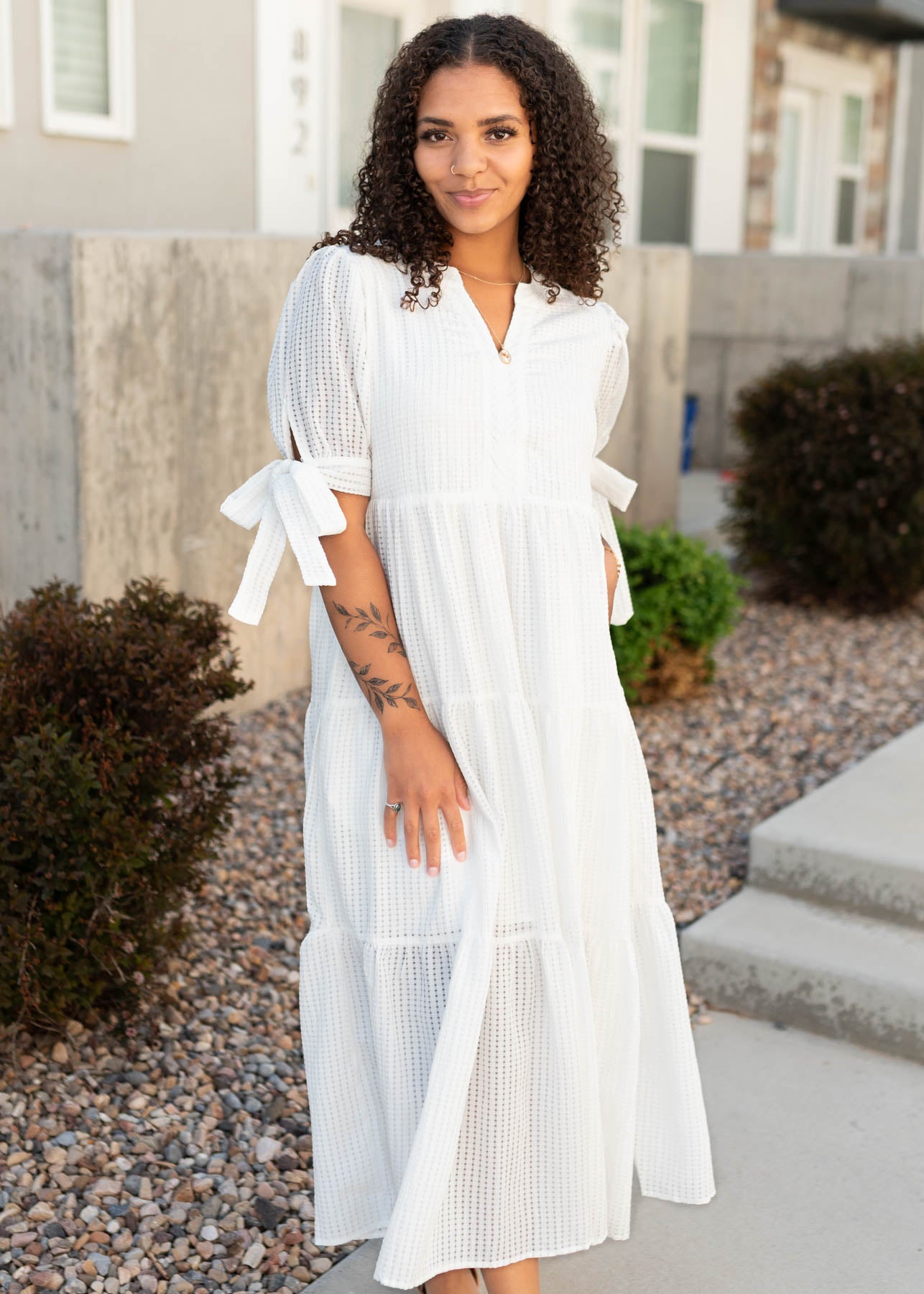White gingham dress with bows on the cuffs