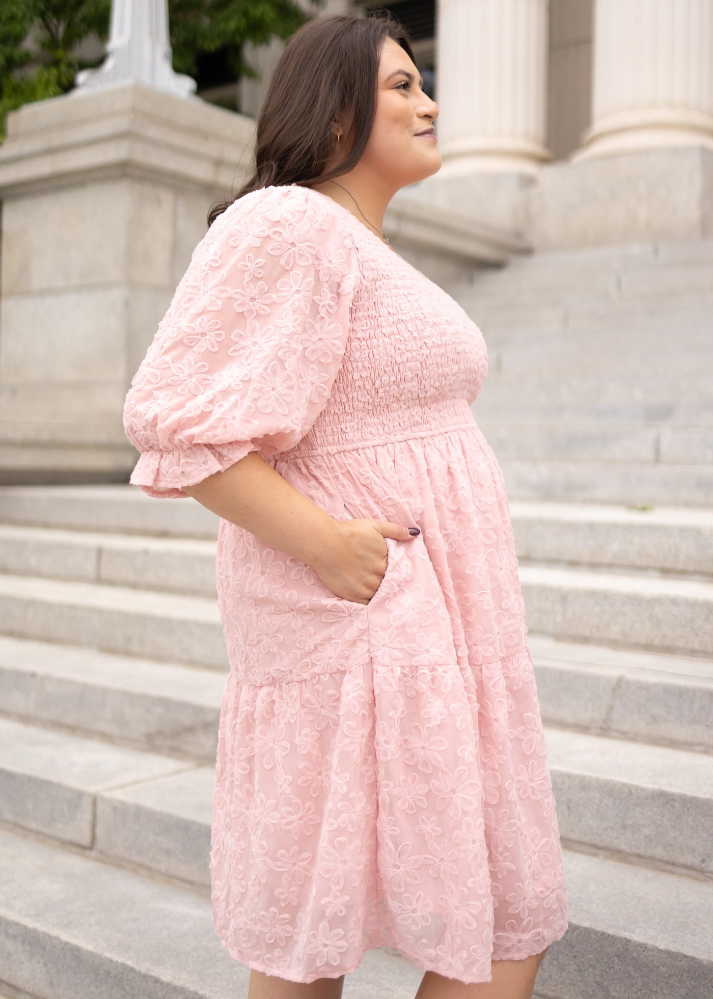 Side view of the plus size blush floral textured dress with pockets