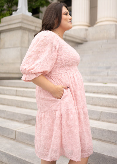 Side view of the plus size blush floral textured dress with pockets