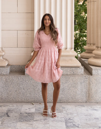 Smocked bodice on the blush floral textured dress with short sleeves