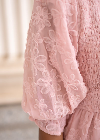 Close up of the sleeve and fabric on the blush floral textured dress