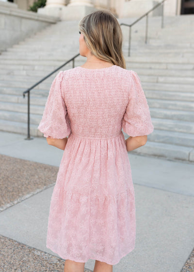 Back view of the smocked bodice on the blush floral textured dress by Lena & Lou