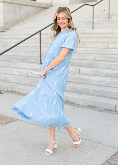White embroidered flowers on the blue floral dress