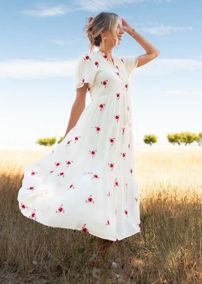 Side view of the ivory floral dress with buttons on the bodice