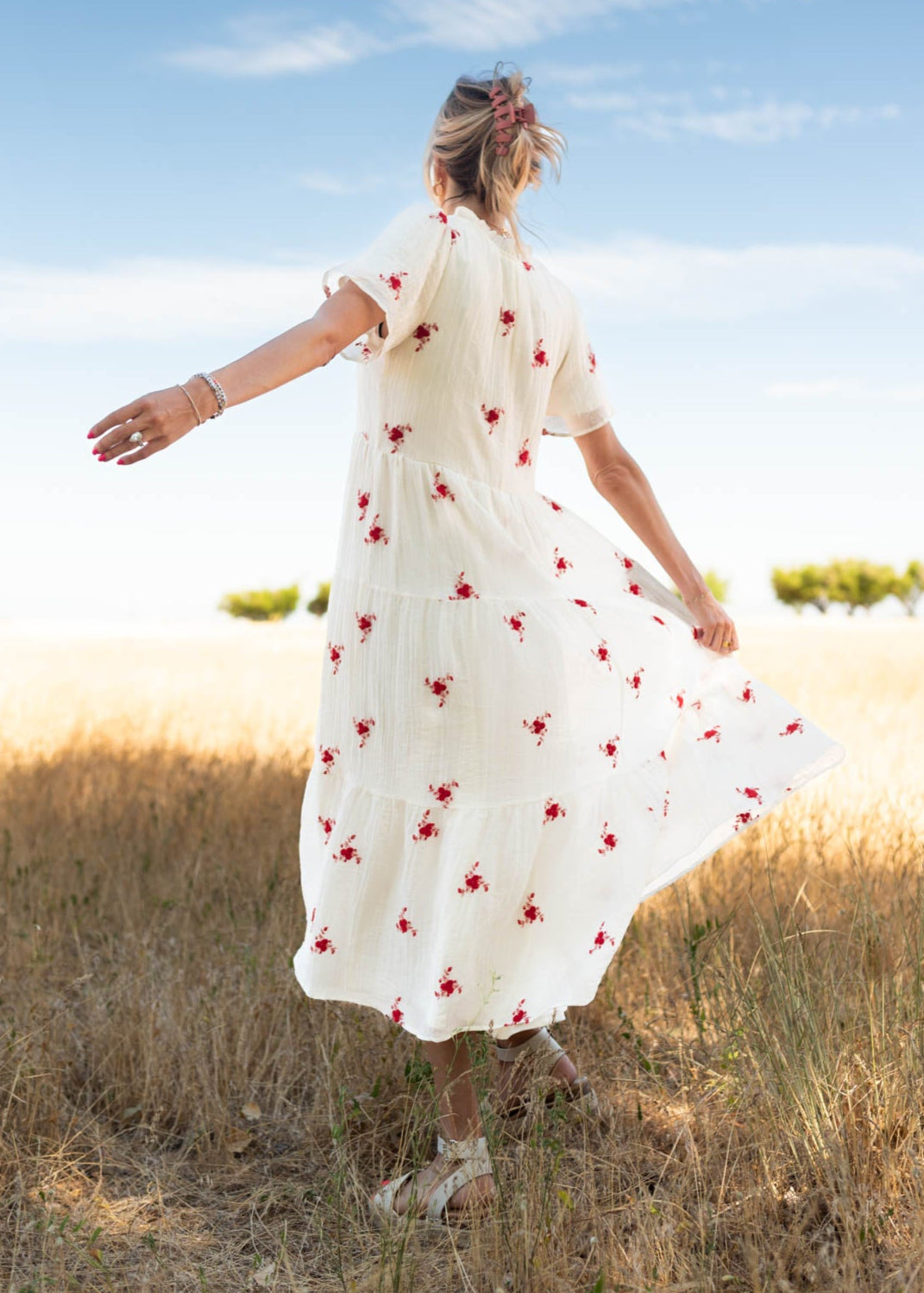 Back view of the ivory floral dress with red flowers