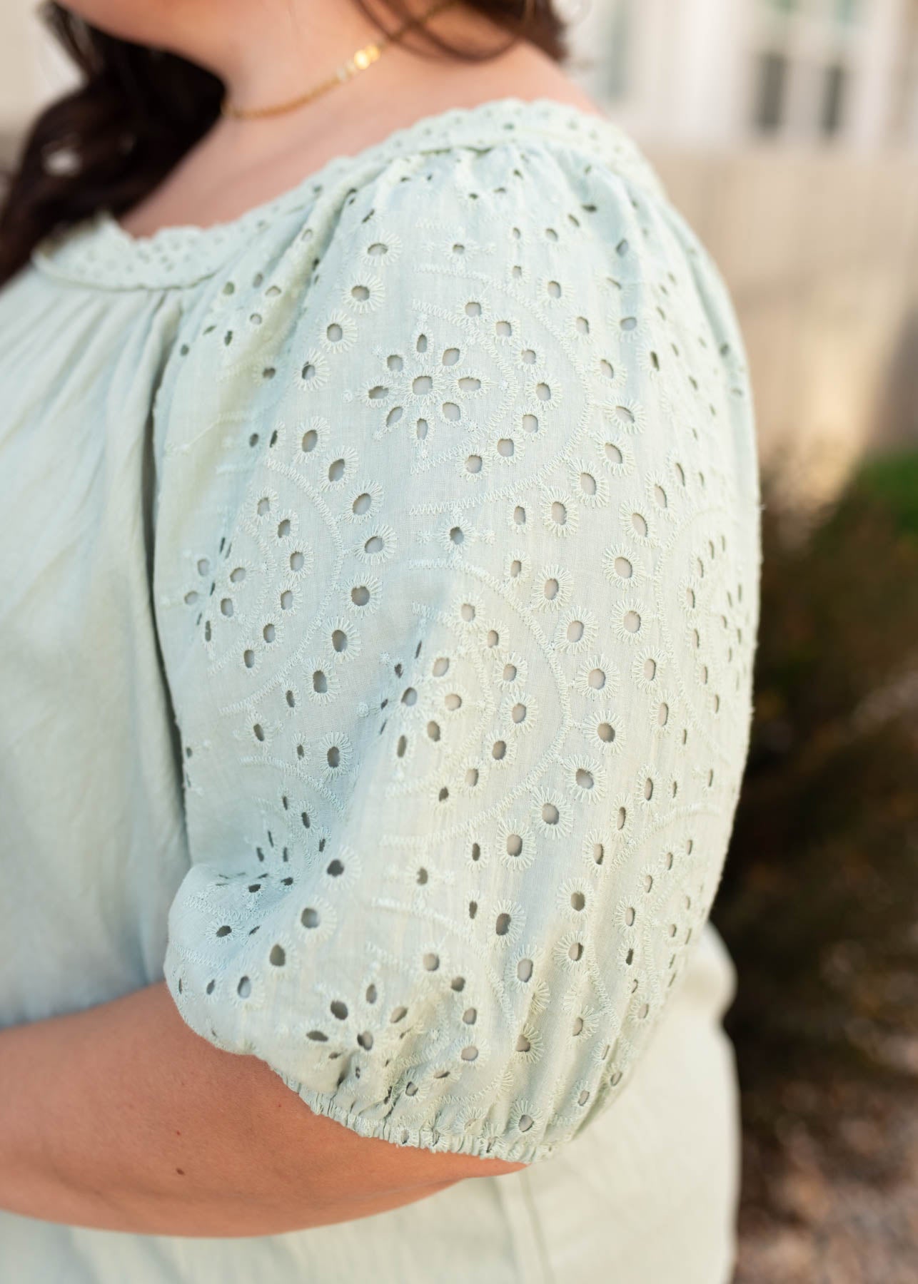 Close up of the eyelet sleeve on the plus size sage top