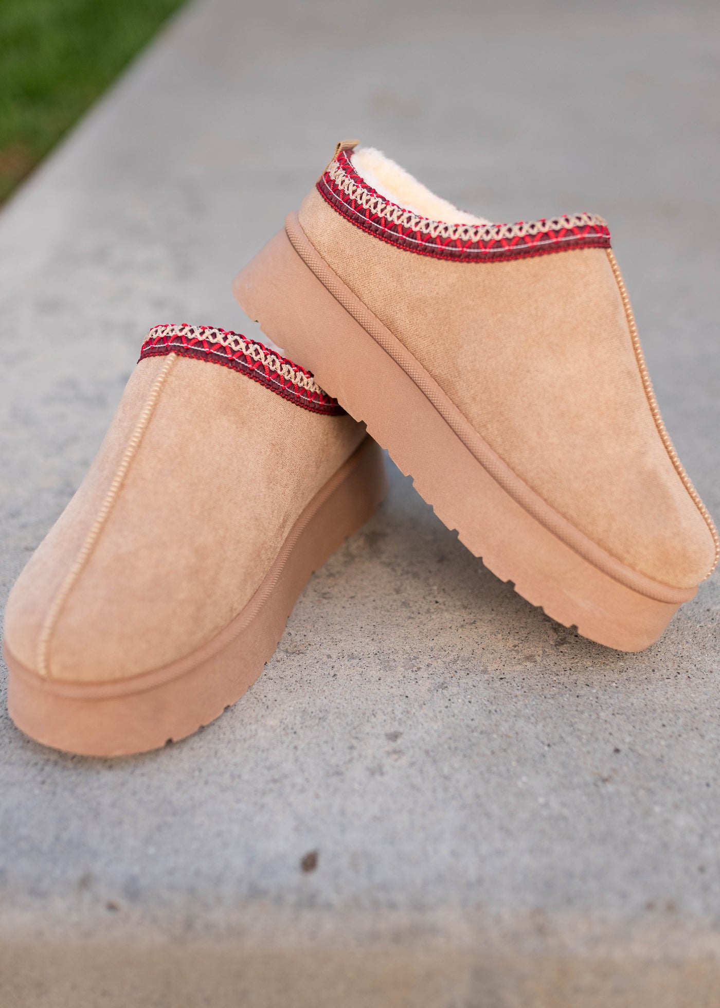 Beige platform clogs with red embroidery