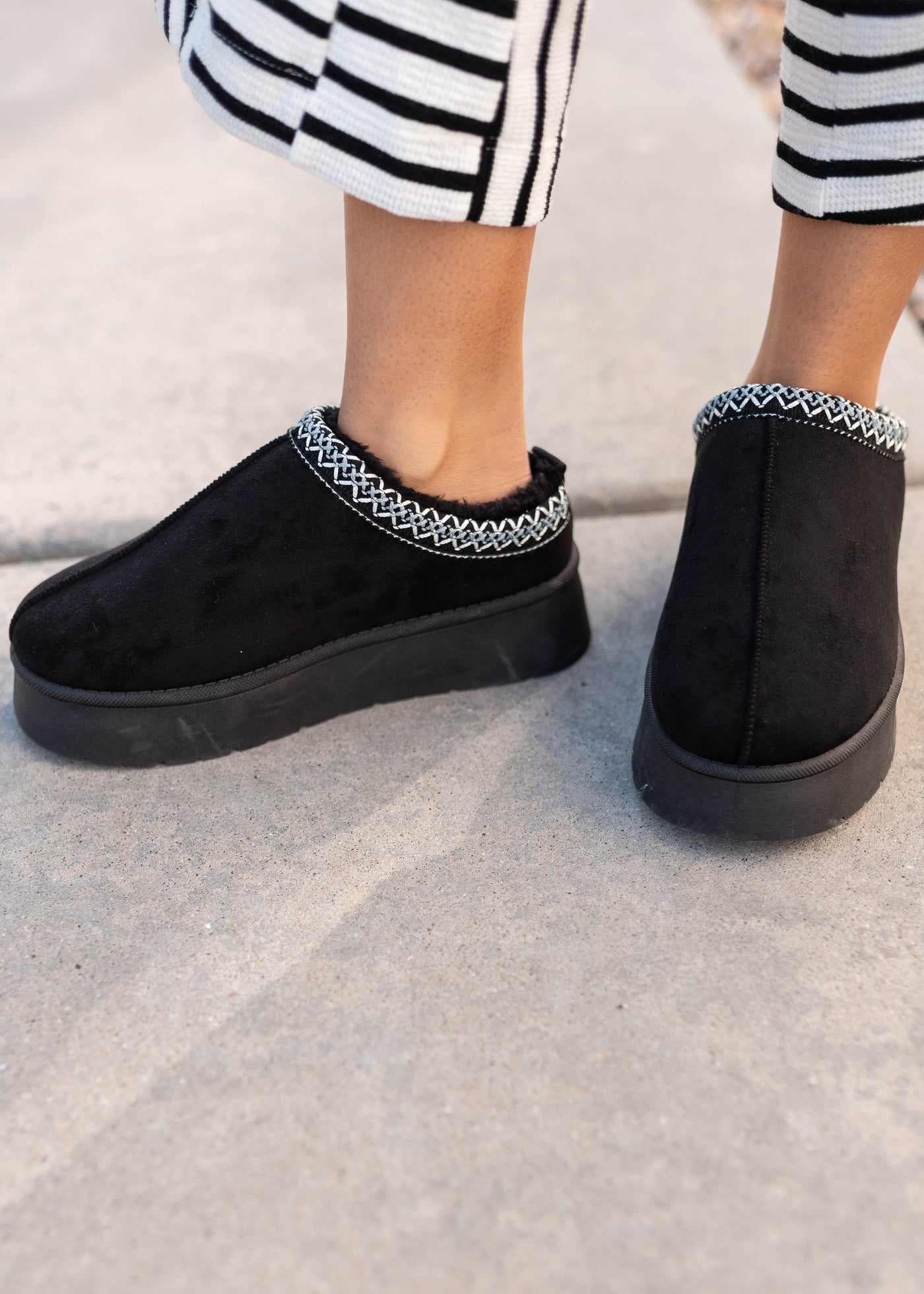 Black platform clogs with embroidery