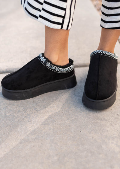 Black platform clogs with embroidery