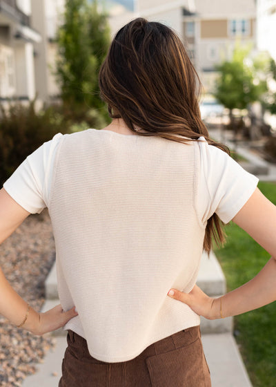 Back view of the beige knit sweater vest