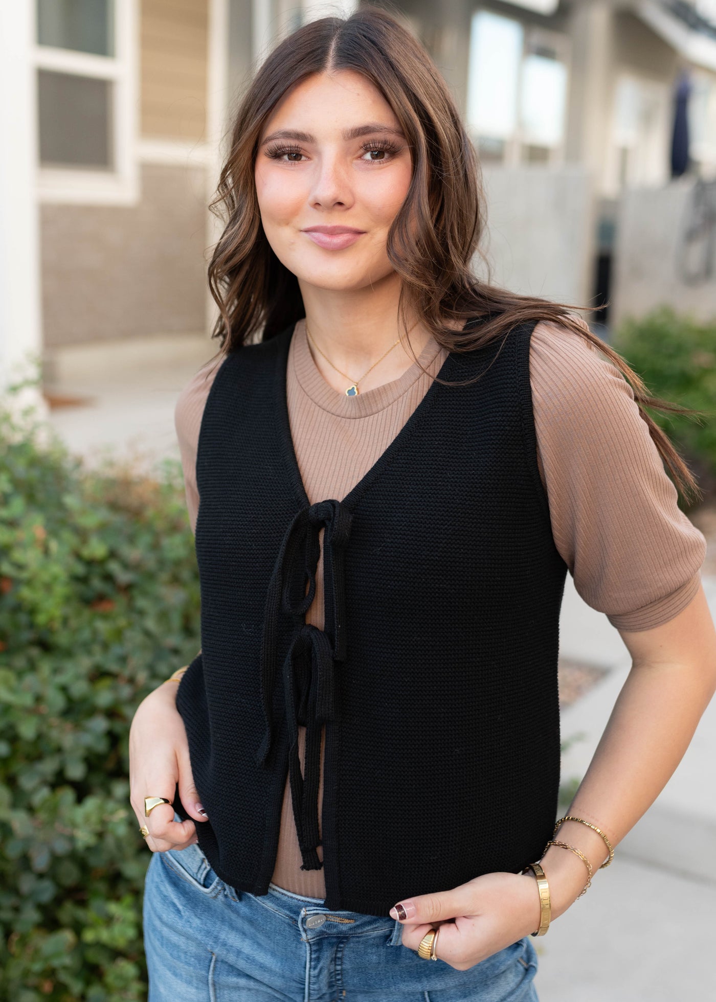 Black knit sweater vest with tie detail