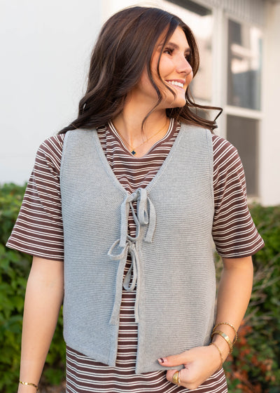 Tie bows on the grey knit sweater vest
