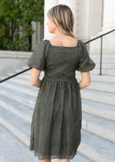 Smocked back of the olive embroidered square neck dress