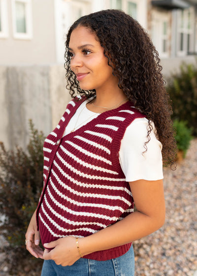 Side view of the burgundy striped sweater vest