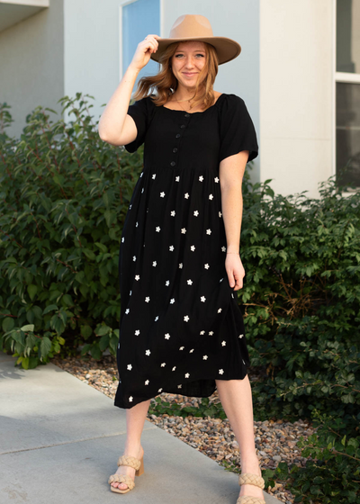 Short sleeve black dress with white flowers on the skirt