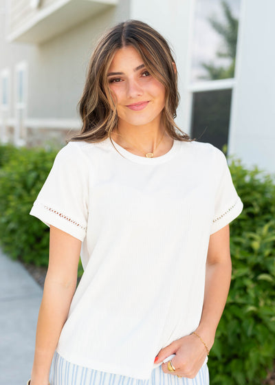 Ivory top with with detail on the sleeves
