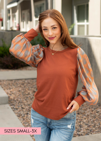 Long sleeve rust top with printed sleeves