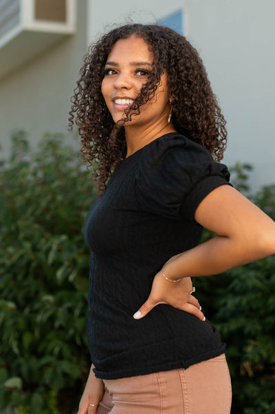 Side view of a short sleeve black top