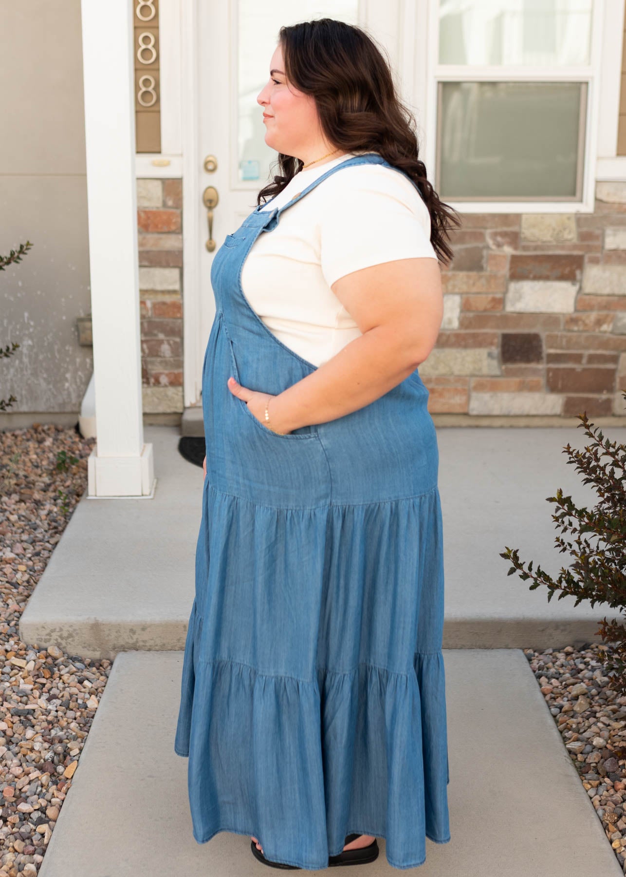 Side view of the modest chambray overall dress with pockets in plus size