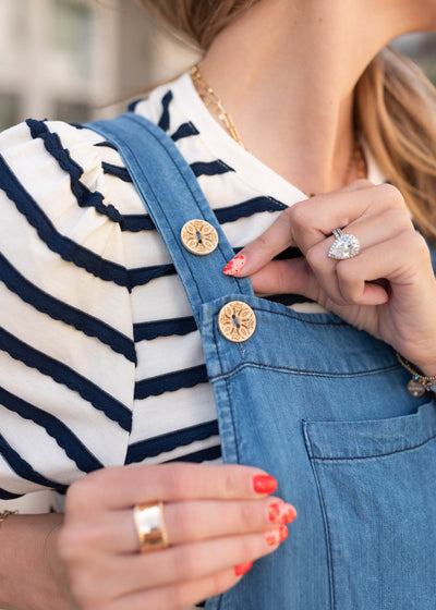 Close up of the carved buttons on the chambray overall dress
