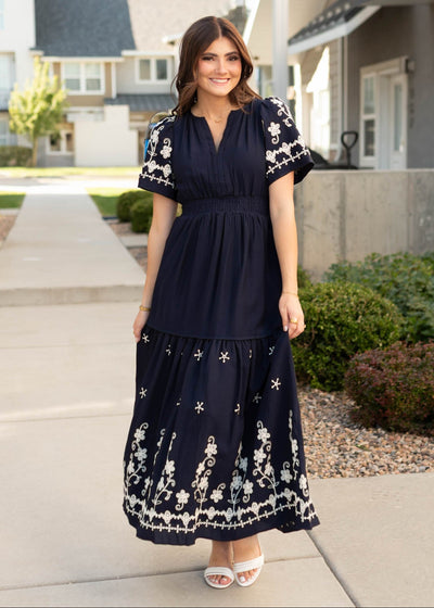 Short sleeve navy embroidered dress with elastic waist and tiered skirt