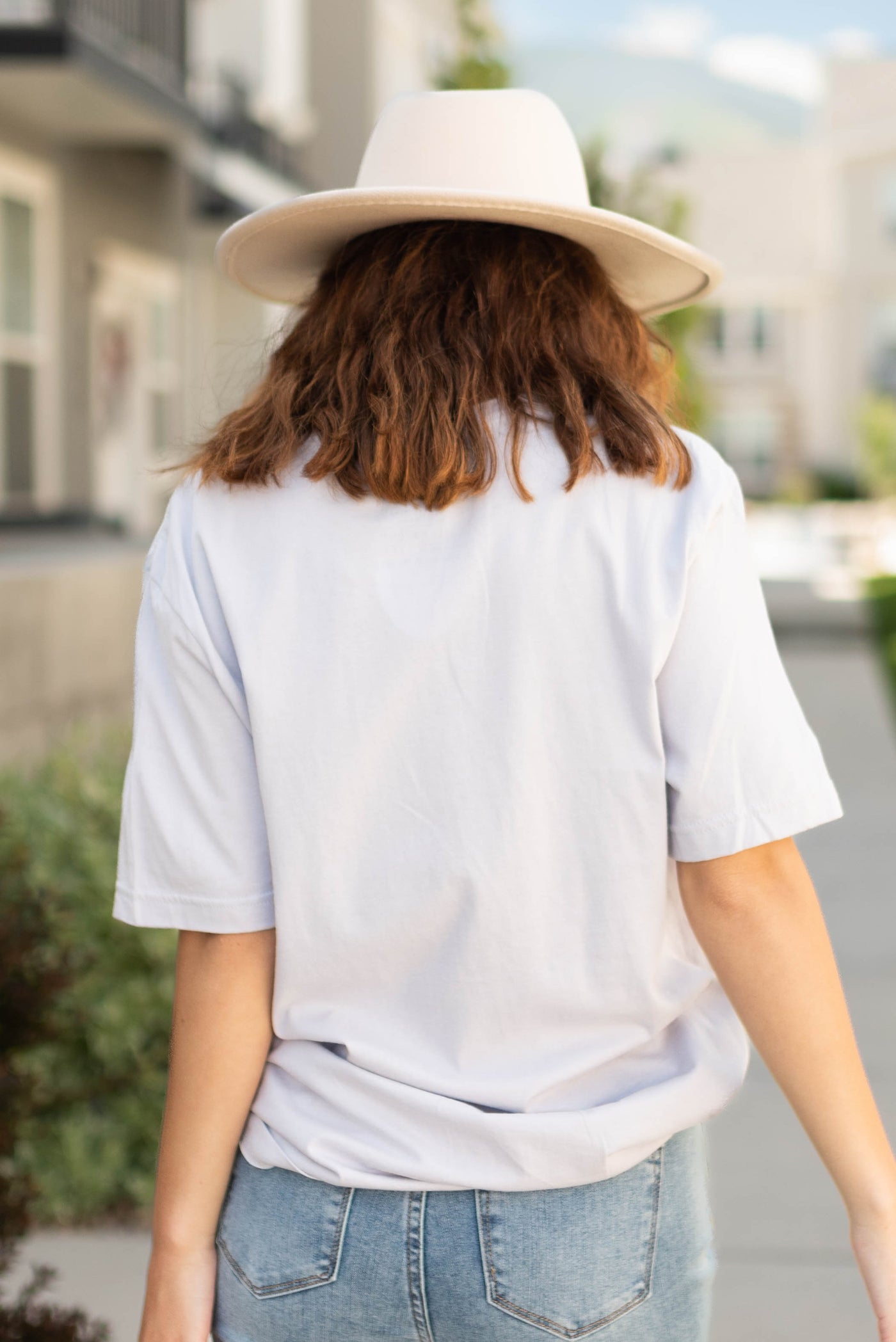 Back view of a stay wild lavender tee