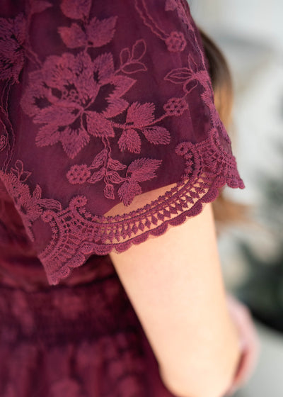Close up of the lace and sleeve on the wine lace dress