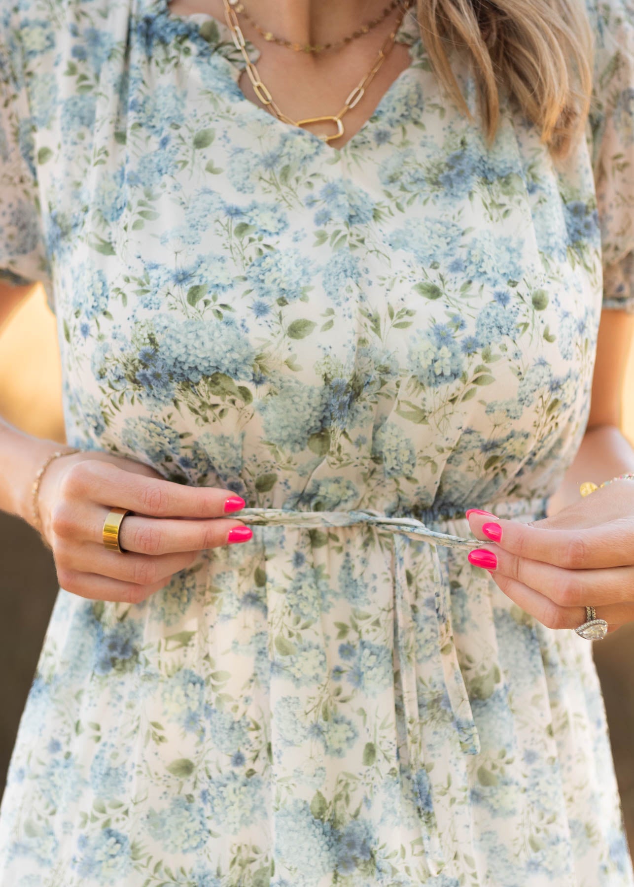 Close up of the tie at the waist on the vintage white floral dress