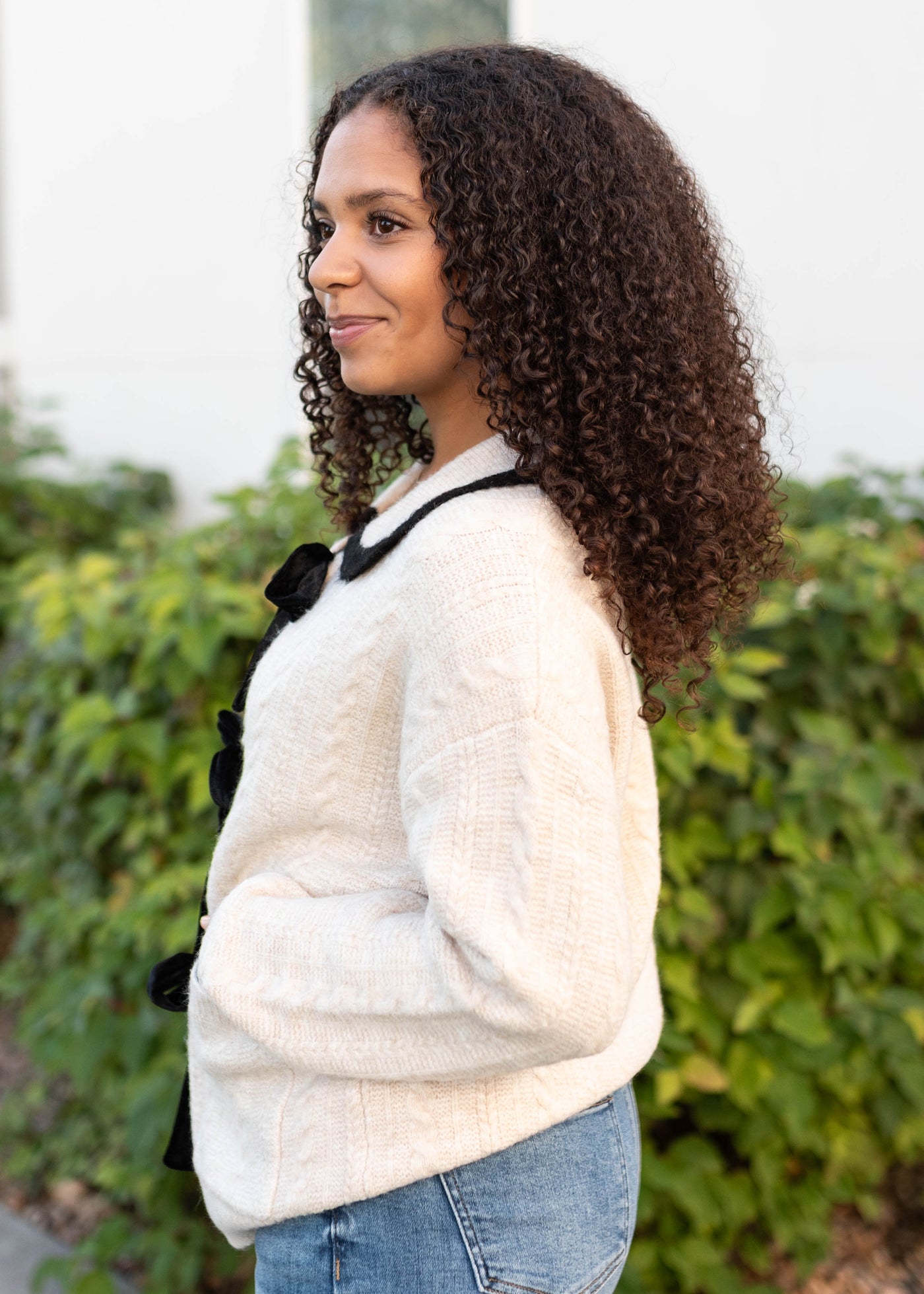Side view of the cream bow cardigan