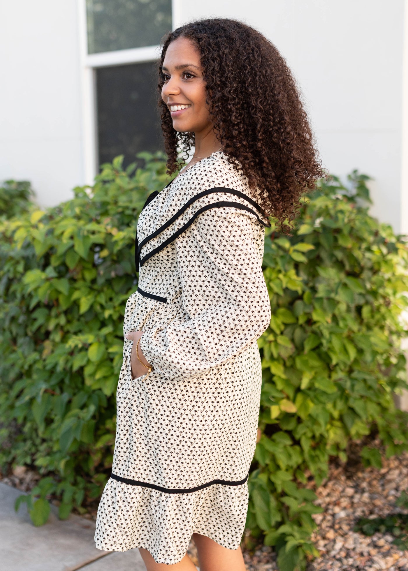 Side view of the cream ruffle dress with pockets