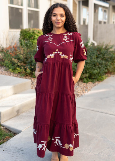 Short sleeve burgundy floral dress with tiered skirt and pockets