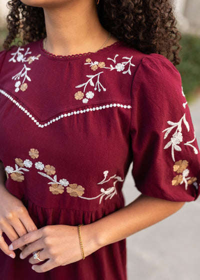 Close up of the embroidery on the burgundy floral dress